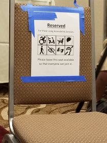 Chair reserved for attendees with mobility impairments, etc.